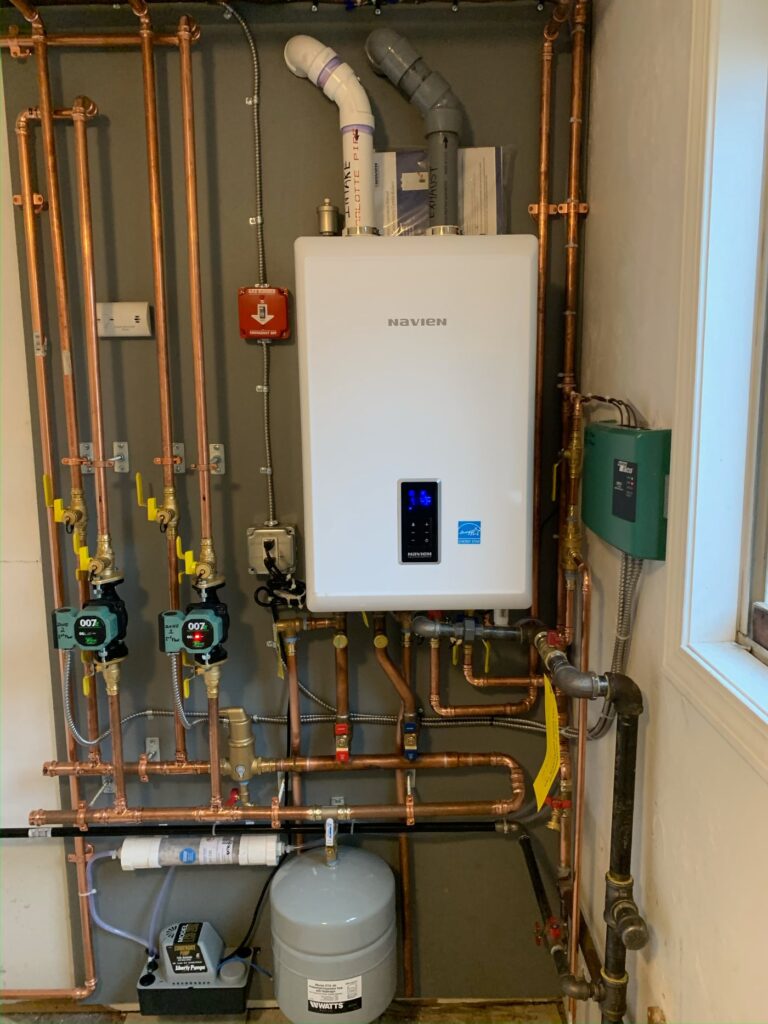 Technician inspecting a residential boiler in a Brookline basement